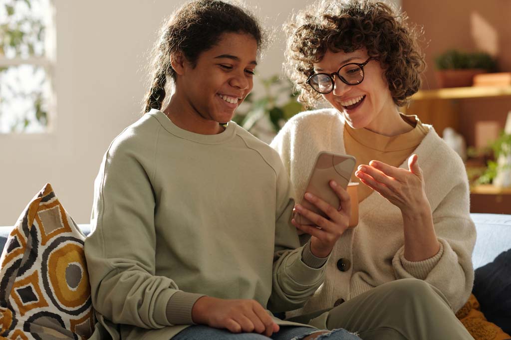 parent and teen smiling